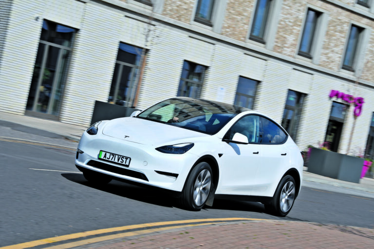 tesla model y cornering through town