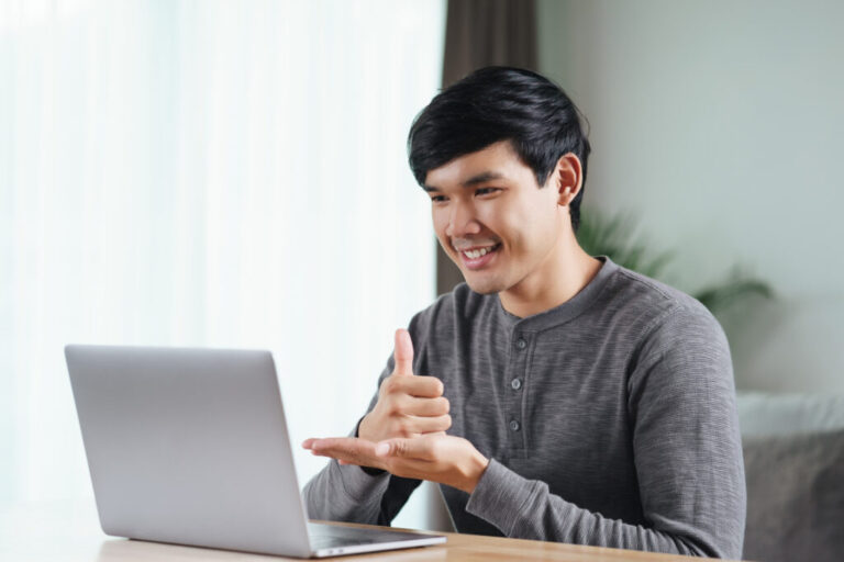 1920 deaf man use laptop video conference communicating in sign language 1024x683